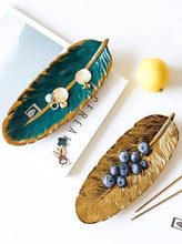 تحميل الصورة في عارض المعرض، Two decorative leaf-shaped platters on a white surface with a lemon and blueberries.
