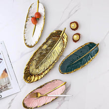 تحميل الصورة في عارض المعرض، Set of decorative leaf-shaped platters in gold, green, and pink on a marble surface.
