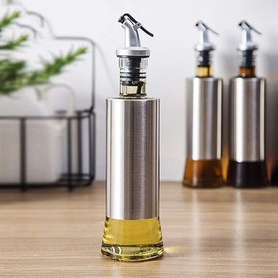 Glass control pot for oil, designed with stainless steel and a clog-free dispenser for easy pouring.