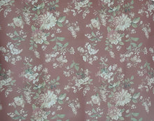 Load image into Gallery viewer, Floral patterned mat with green and white flowers on a pinkish-brown background
