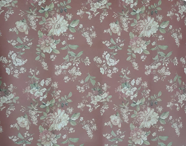 Floral patterned mat with green and white flowers on a pinkish-brown background