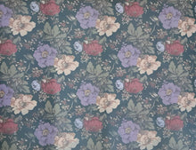 Load image into Gallery viewer, Floral patterned placemat with colorful flowers on a teal background
