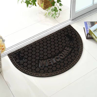 Black doormat with 'Welcome' text on a white floor