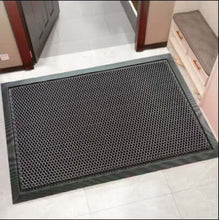 Load image into Gallery viewer, Textured black doormat on a white floor with a door in the background
