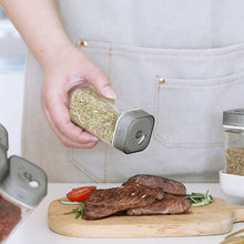 Load image into Gallery viewer, Shakers - Glass Spice seasoning jars Set of 2 with Plastic Lids &amp; Holder in use over cooked meat.
