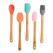 تحميل الصورة في عارض المعرض، Colorful mini silicone spatulas and utensils with wooden handles on a wooden surface.
