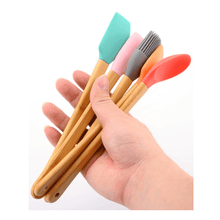 تحميل الصورة في عارض المعرض، Colorful mini heat resistant silicone spatulas and utensils with wooden handles held in a hand.
