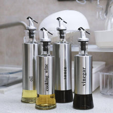 تحميل الصورة في عارض المعرض، Stainless steel olive oil and vinegar dispensers with labels for cooking wine, sauce, oil, and vinegar.
