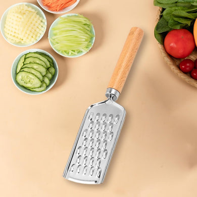 Stainless steel cheese and lemon zester grater with wooden handle, surrounded by fresh sliced vegetables.