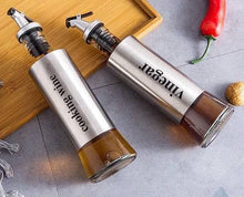 تحميل الصورة في عارض المعرض، Stainless steel olive oil and vinegar dispenser set on a wooden tray, featuring labels for cooking wine and vinegar.
