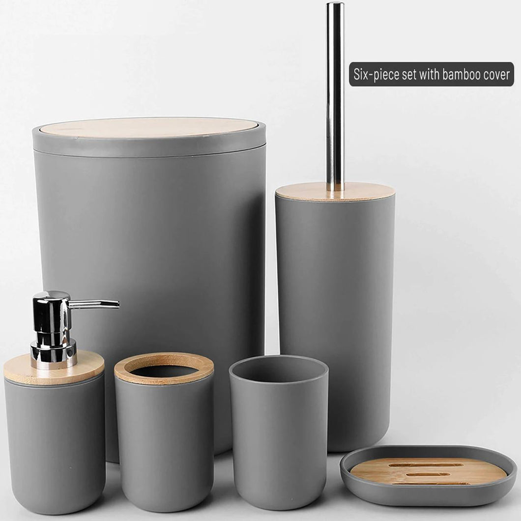 Gray bathroom accessory set with wooden accents on a light gray background