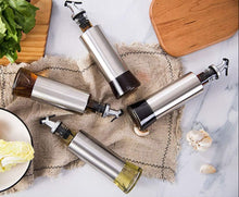تحميل الصورة في عارض المعرض، Stainless steel oil and vinegar dispenser set with glass bottles on a marble countertop, ideal for cooking.
