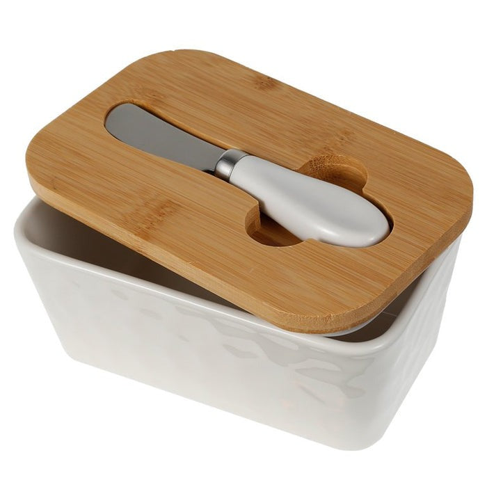 Porcelain butter dish with bamboo lid and spreader, perfect for storing butter up to 250g.