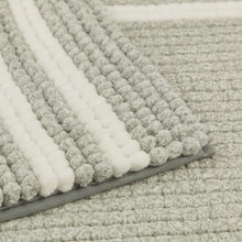 تحميل الصورة في عارض المعرض، Close-up of a textured gray rug with a white border
