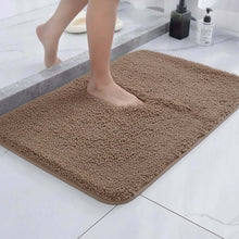 تحميل الصورة في عارض المعرض، Brown bath mat on a bathroom floor with a person stepping onto it.
