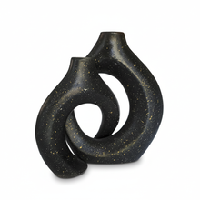 تحميل الصورة في عارض المعرض، Black ceramic vase with a unique, abstract design on a white background
