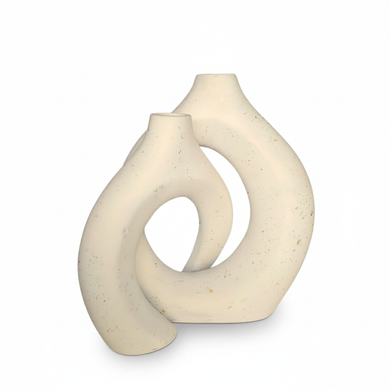 White ceramic vase with a modern, abstract design on a white background