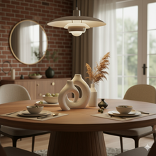 تحميل الصورة في عارض المعرض، Dining room with a round wooden table, modern pendant light, and decorative vases.
