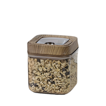 Load image into Gallery viewer, Glass jar with wooden lid containing granola on a white background
