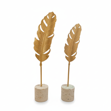 تحميل الصورة في عارض المعرض، Two gold feather-shaped decorative items on stone bases against a white background
