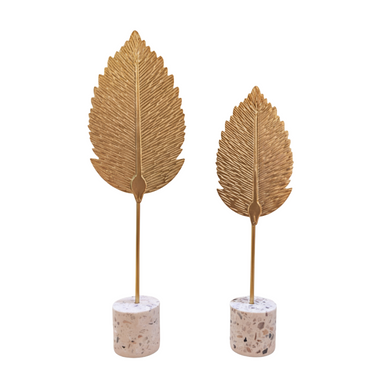 Two gold leaf-shaped planters on a white background