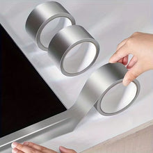 Load image into Gallery viewer, Person applying a roll of silver tape to a surface
