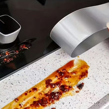 Load image into Gallery viewer, Person pouring a liquid from a white container onto a piece of food on a stovetop.
