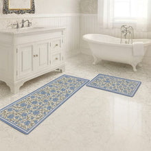 تحميل الصورة في عارض المعرض، Bathroom with floral-patterned rugs on the floor, vanity, and bathtub.
