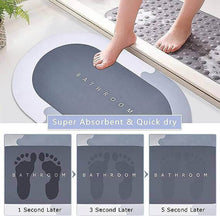 Load image into Gallery viewer, Anti-slip bathroom mat showing water absorption and quick-drying features with foot impressions on the mat.
