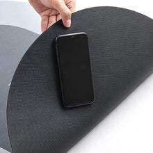 Load image into Gallery viewer, Hand holding a black anti-slip mat with a smartphone placed on its surface, showcasing functionality and grip.
