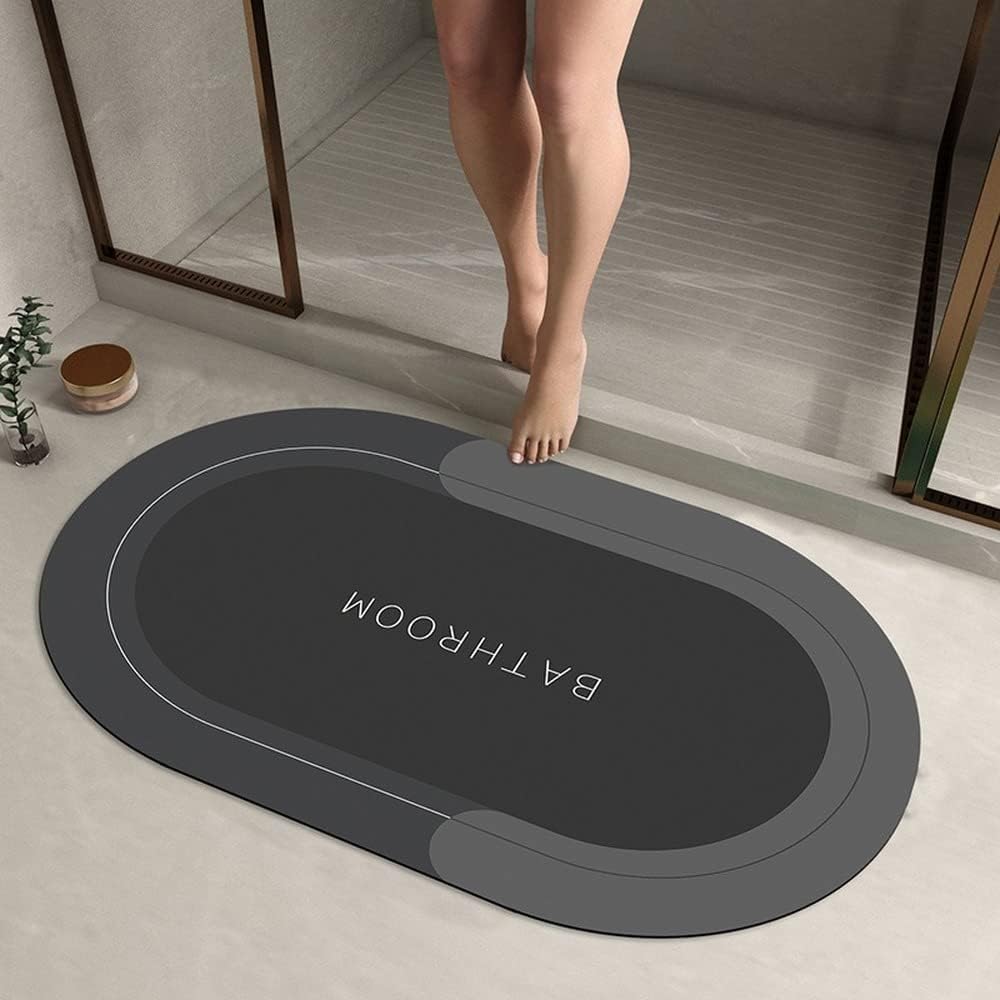 Gray bath mat with 'Bathroom' text on a bathroom floor.