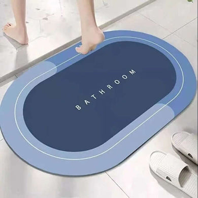 Blue bathroom mat with 'Bathroom' text on a tiled floor.