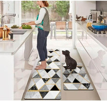 Load image into Gallery viewer, Person standing on a geometric patterned kitchen mat with a dog nearby.
