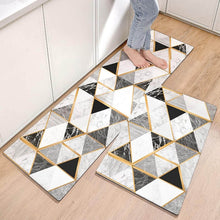 Load image into Gallery viewer, Geometric patterned rug on a wooden floor with a person wearing jeans.
