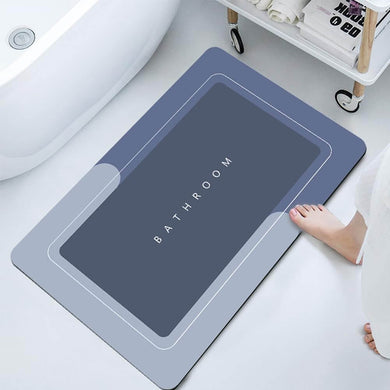Gray bath mat with 'Bathroom' text on a white floor