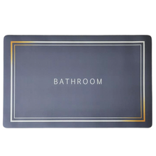 Load image into Gallery viewer, A rectangular, non-slip rubber bathroom mat in gray with suction cups, featuring the word &#39;BATHROOM&#39; in a simple, bold font at the center.
