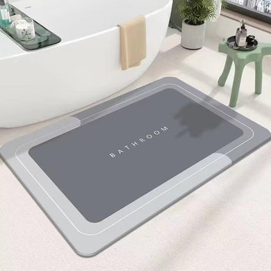 Gray bath mat with 'Bathroom' text on a bathroom floor