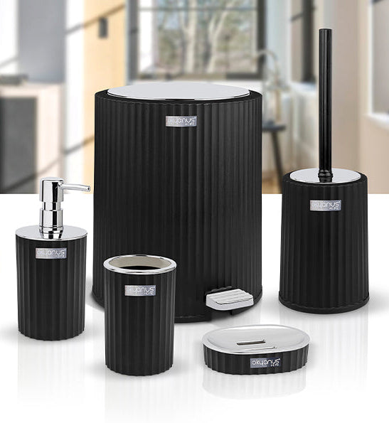 Set of black bathroom accessories including a toilet brush holder, soap dispenser, and trash can in a modern bathroom setting.