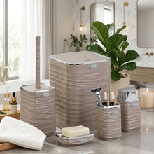 تحميل الصورة في عارض المعرض، Bathroom accessory set with textured containers and toiletries on a reflective surface.
