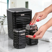 تحميل الصورة في عارض المعرض، Black storage units with a hand interacting with one of them, on a white background.
