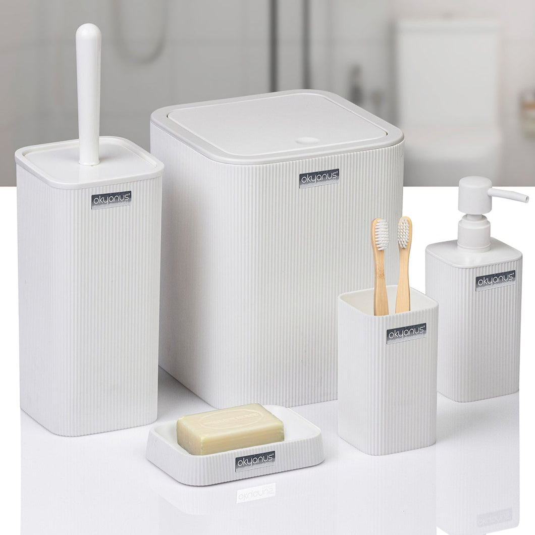White bathroom accessories set including a trash can, soap dish, and toothbrush holder on a light background.