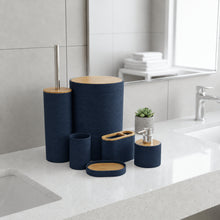 تحميل الصورة في عارض المعرض، A coordinated bathroom accessory set in dark navy fabric with light wood lids, arranged on a white countertop beside a sink. The set includes a tall toothbrush holder with a visible toothbrush, a tissue box cover, a cup, a soap dish, and a small soap dispenser with a small potted succulent behind it.
