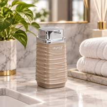 Load image into Gallery viewer, Beige Luna soap dispenser with silver pump on a counter
