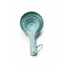 تحميل الصورة في عارض المعرض، A set of nested measuring cups in a light mint green color, featuring a carrying loop at the handle, shown on a clean white background.
