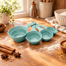 تحميل الصورة في عارض المعرض، A set of four pastel aqua measuring cups and spoons arranged on a clean white background.
