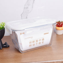 Load image into Gallery viewer, Clear food storage container with white interior on a wooden surface, featuring text and branding.
