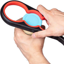 Load image into Gallery viewer, A hand holding a black and red ergonomic jar opener with a blue lid.
