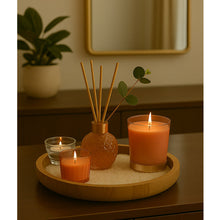 Load image into Gallery viewer, Candle holder with three candles and a diffuser on a wooden tray, with a plant and mirror in the background.
