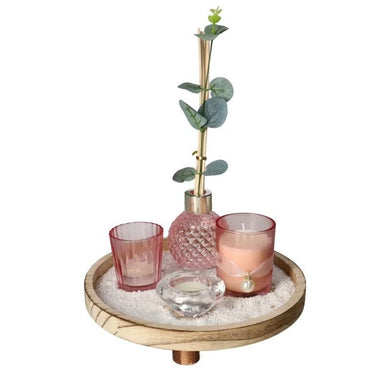 Decorative tray with a plant, glasses, and candle on a white background