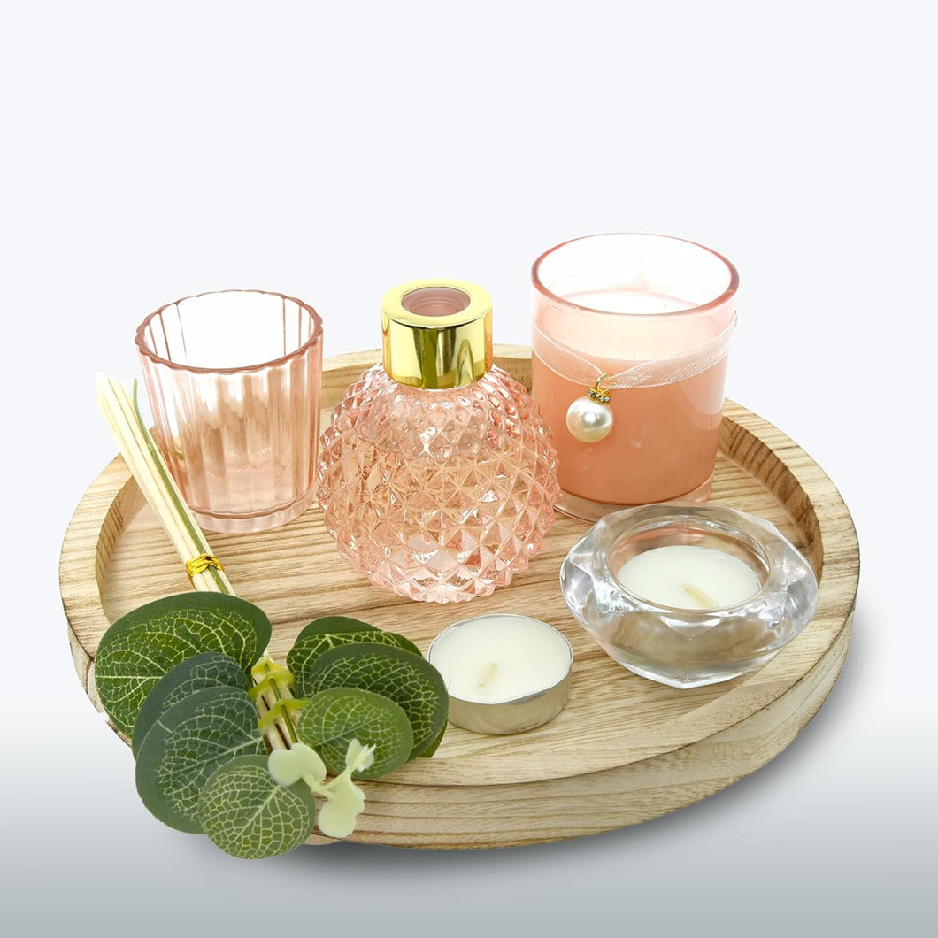 Decorative items including candles and a diffuser on a wooden tray with a light background